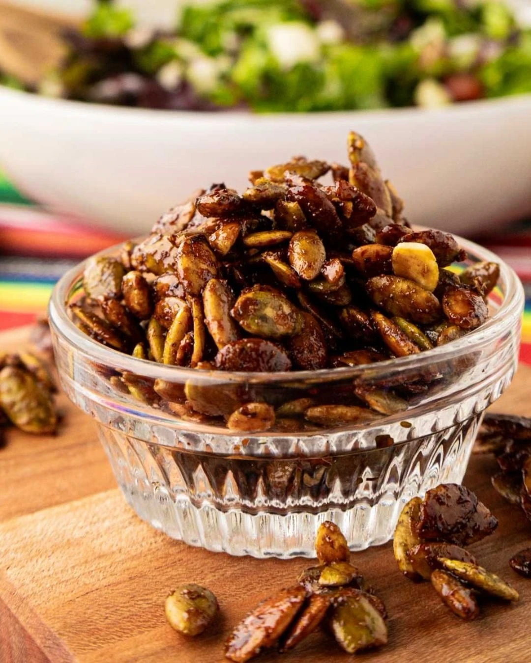 Roasted seasoned pumpkin seeds in a glass bowl