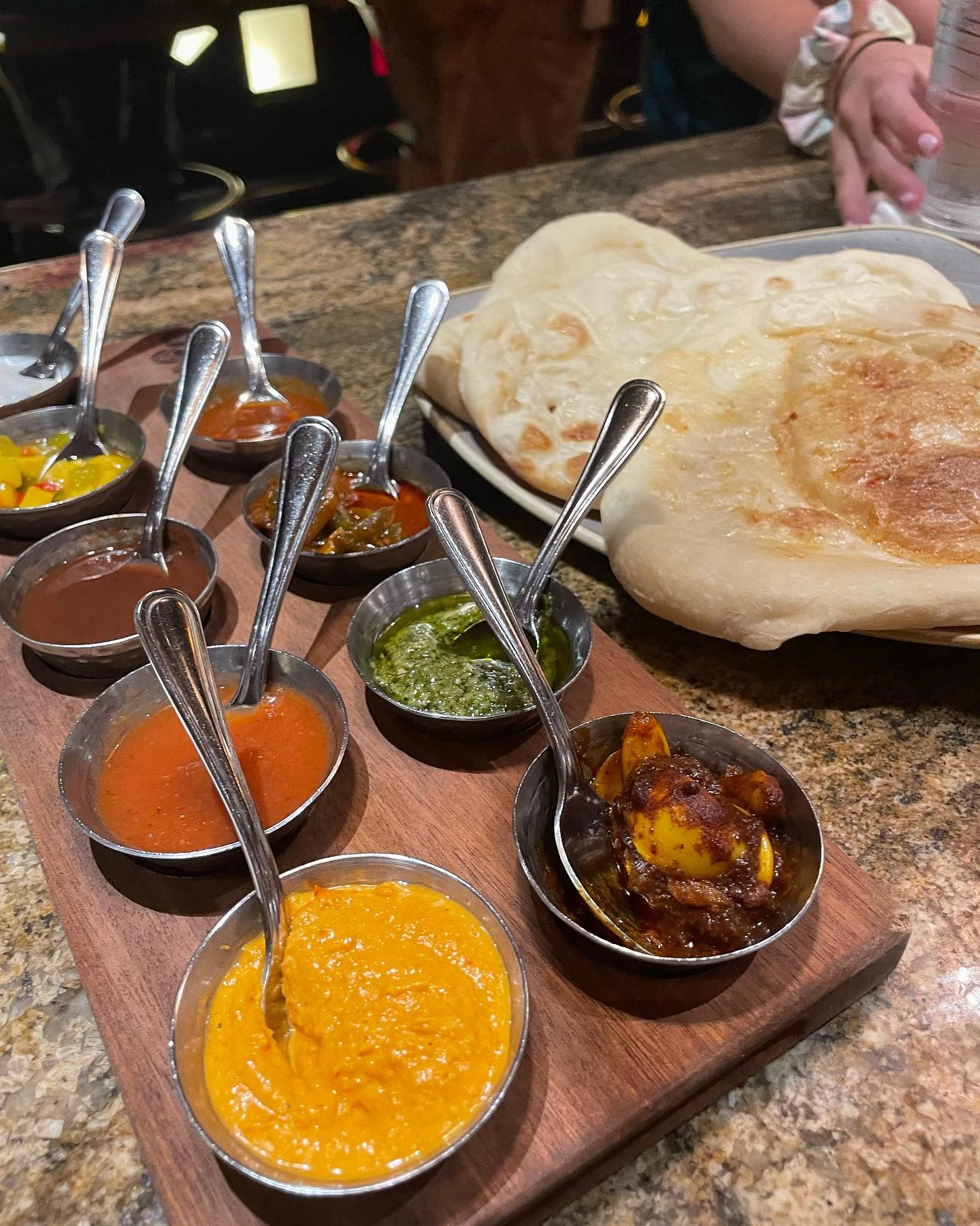 Sanaa’s Indian-style bread service with warm flatbreads and colorful chutneys and dips