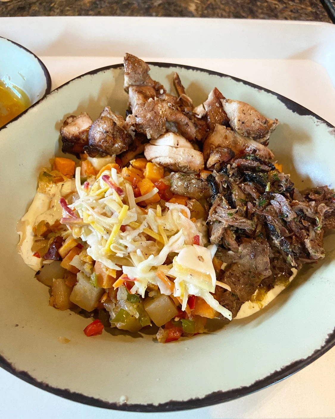 Satu’li Canteen bowl with grilled chicken, braised beef, potato hash and slaw