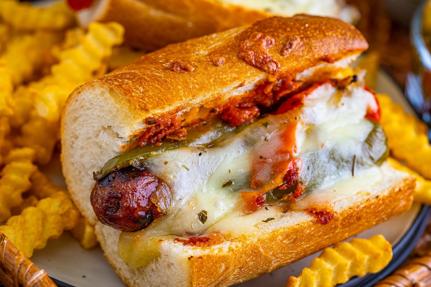 Grilled sausage with peppers, onions and melted provolone in a toasted roll