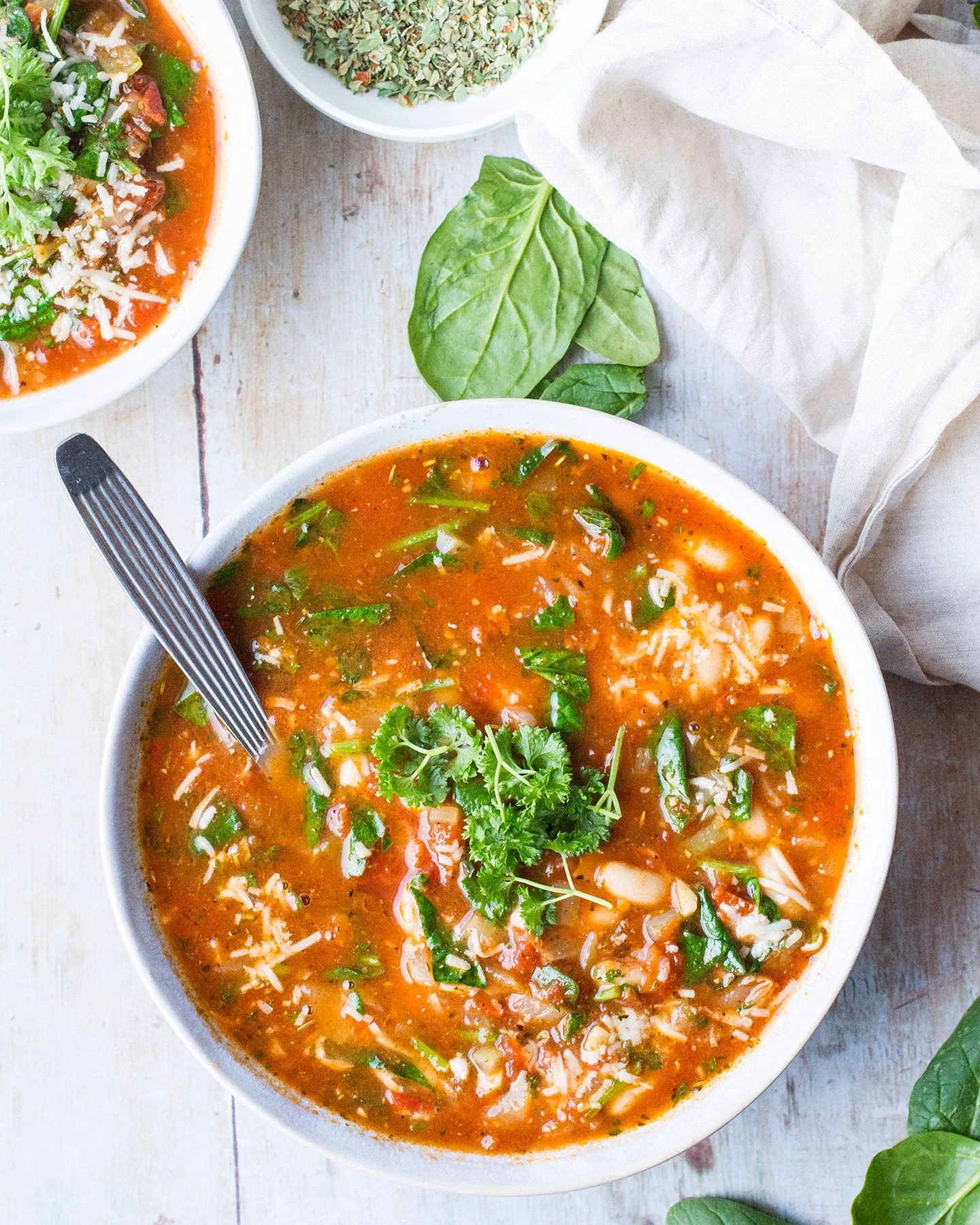 Tomato soup with white beans and chopped herbs