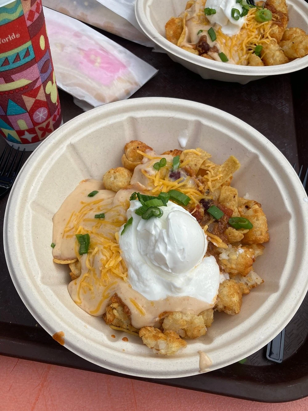 Totchos topped with chili, cheese, sour cream, and corn chips at Woody’s Lunch Box