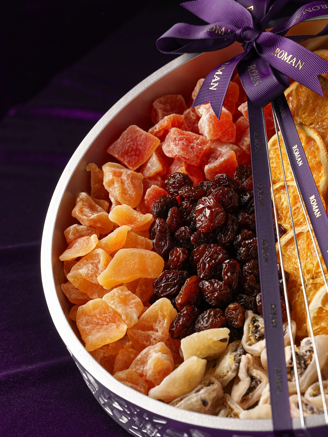 Assorted dried fruit including raisins, citrus slices and tropical fruit