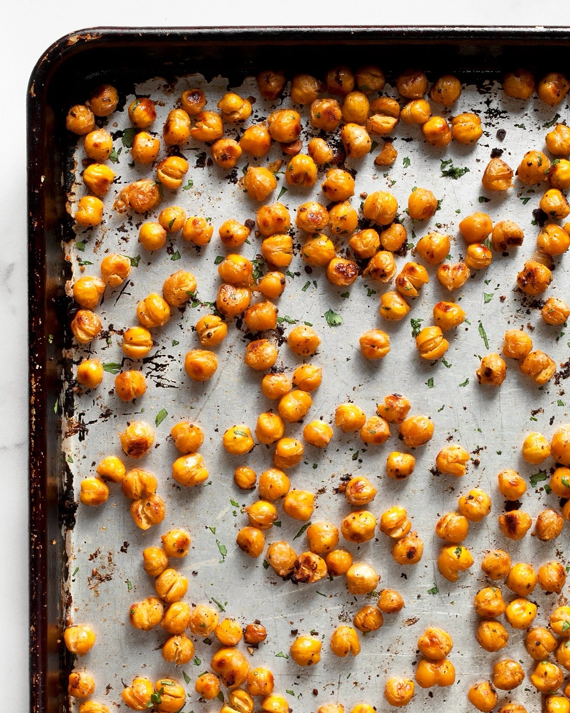 Golden roasted chickpeas spread across a baking tray
