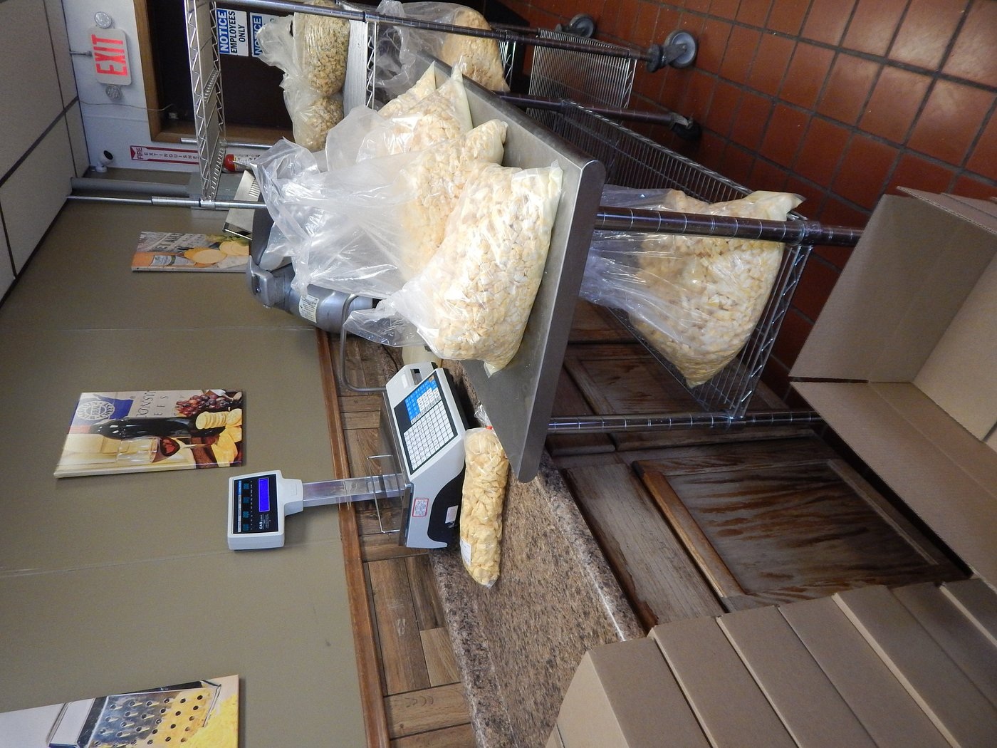 Bags of Arena cheese curds beside the production viewing area