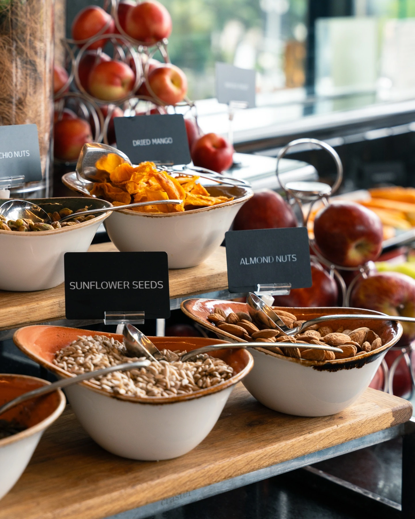 Hotel breakfast buffet with fresh apples, nuts, seeds and dried fruit